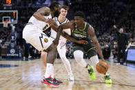 Minnesota Timberwolves guard Anthony Edwards dribbles towards the basket against Denver Nuggets center DeAndre Jordan (6), left, and guard Christian Braun during the first half of an NBA basketball game, Sunday, Feb. 5, 2023, in Minneapolis. (AP Photo/Abbie Parr)