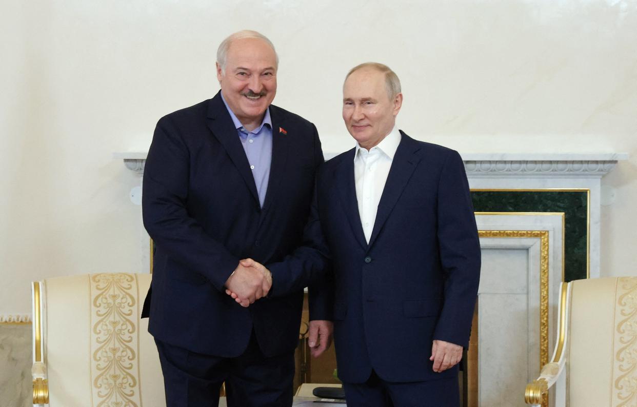 Russian president Vladimir Putin shakes hands with Belarusian president Alexander Lukashenko (via REUTERS)