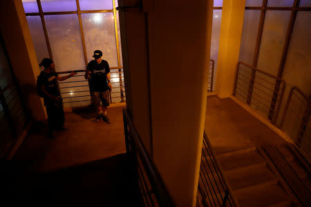 Vad Him (L) and Georgy Lanchevskiy of Rudex team talk in stairwell after a rooftop exploration in Moscow, Russia, August 14, 2017. REUTERS/Maxim Shemetov