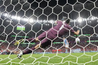 Morocco's goalkeeper Yassine Bounou saves a penalty shootout kick by Spain's Sergio Busquets during the World Cup round of 16 soccer match between Morocco and Spain, at the Education City Stadium in Al Rayyan, Qatar, Tuesday, Dec. 6, 2022. (AP Photo/Luca Bruno)