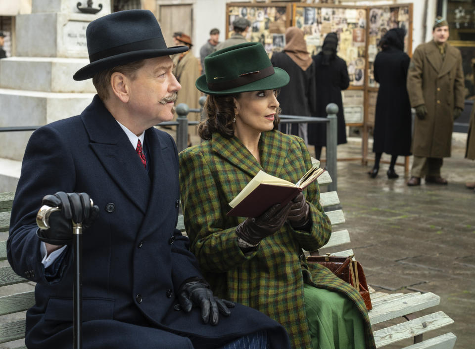 This image released by 20th Century Studios shows Kenneth Branagh as Hercule Poirot, left, and and Tina Fey as Ariadne Oliver in a scene from "A Haunting in Venice." (20th Century Studios via AP)