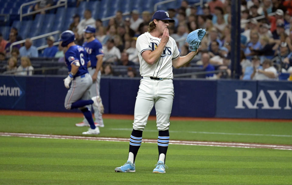 Tampa Bay Rays starter Ryan Pepiot, right, reaches for a new ball as Texas Rangers' Josh Jung (6) circles the bases after hitting a three-run home run during first the inning of a baseball game Monday, April 1, 2024, in St. Petersburg, Fla. (AP Photo/Steve Nesius)