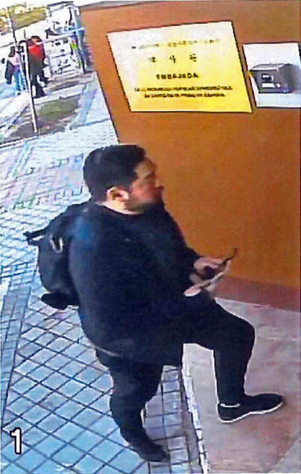 This Feb. 22, 2019 image from surveillance video at the North Korean Embassy to Spain in Madrid, contained in Department of Justice documents presented by federal prosecutors, shows U.S. Marine veteran Christopher Ahn as he prepares to enter the embassy. Ahn, suspected of involvement in a mysterious dissident group's February raid on North Korea's embassy, has been denied bond by a federal judge and must stay in custody. Ahn appeared in a Los Angeles courtroom on Tuesday, April 23. The charges against Ahn haven't been made public. (U.S. Department of Justice via AP)