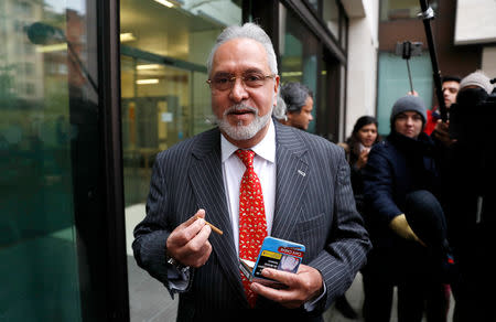 Vijay Mallya has a break outside the court house as he waits for his extradition case to be heard at Westminster Magistrates Court, in London, Britain, December 10, 2018. REUTERS/Peter Nicholls