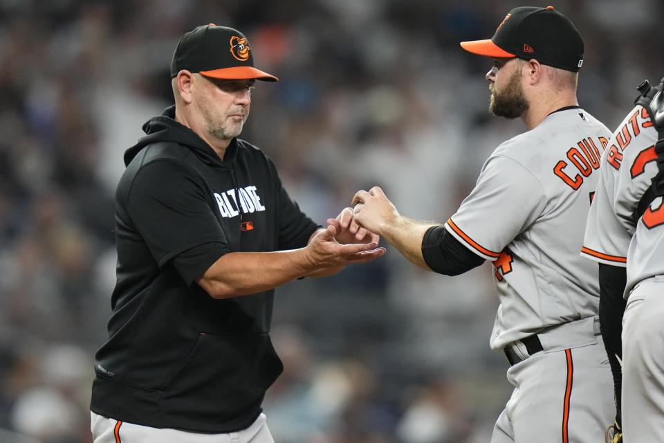 Baltimore Orioles manager Brandon Hyde, left, takes the ball from relief pitcher Danny Coulombe during the eighth inning of a baseball game against the New York Yankees, Monday, July 3, 2023, in New York. (AP Photo/Frank Franklin II)