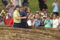 Tiger Woods and Rory McIlroy, of North Ireland, walks on the 13th hole during the first round of the PGA Championship golf tournament, Thursday, May 19, 2022, in Tulsa, Okla. (AP Photo/Matt York)