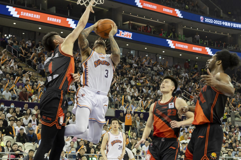 In this photo released by China's Xinhua News Agency, Melo Trimble (3) of the Shanghai Sharks goes for a lay-up during a playoff basketball game between the Shanghai Sharks and the Jiangsu Dragons in Shanghai, Friday, April 14, 2023. The Chinese Basketball Association has ordered an investigation into a championship round game that ended with a last-minute, come-from-behind win following an series of turnovers. (Wang Xiang/Xinhua via AP)