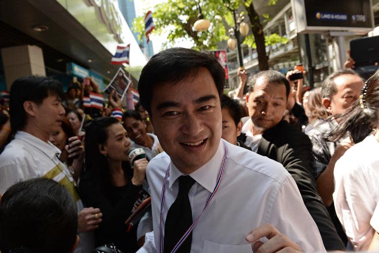 Former Thai prime minister Abbhisit Vejjajiva (centre) walks through a crowd of supporters during a rally against an amnesty bill in Bangkok's financial district of Silom, on November 4, 2013