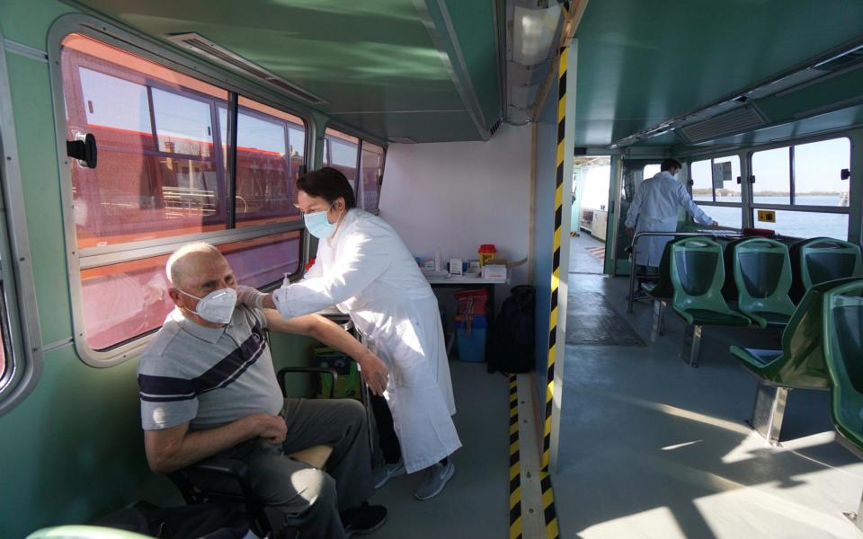 A man receives a covid19 vaccine on board the steamboat ''vaporetto'' of the Venice Municipal Transport Company, transformed into a mobile clinic for the anti-covid19 vaccination campaign, sailing to the island of Sant'Erasmo, in the lagoon north of Venice - Andrea Merola/EPA-EFE/Shutterstock 