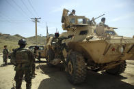 File - In this Wednesday, April 29, 2020 file photo, Afghan special forces stand guard at the site of a suicide bomber attack on the outskirts of Kabul, Afghanistan.Afghanistan has been at war for more than 40 years, first against the invading Soviet army that killed more than 1 million people, then feuding mujahedin groups in a bitter civil war followed by the repressive Taliban rule and finally the latest war that began after the 2001 U.S.-led coalition invasion that toppled the Taliban government. (AP Photo/Rahmat Gul, File)