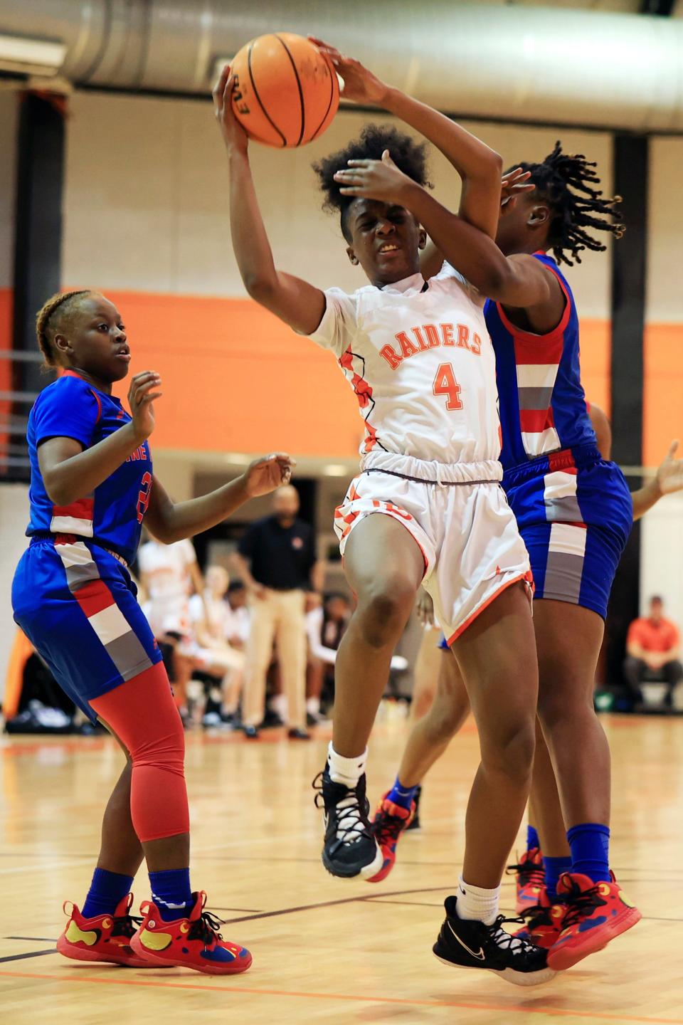 Orange Park's Eris Lester (4) is guarded by Pine Forest's Ti'yuenah Robinson (33) as Makevia House (21), left, looks on during the first quarter of a FHSAA Region 1-5A girls basketball championship game Friday, Feb. 18, 2022 at Orange Park High School in Orange Park. The Pine Forest Eagles knocked off the Orange Park Raiders 70-55. [Corey Perrine/Florida Times-Union]