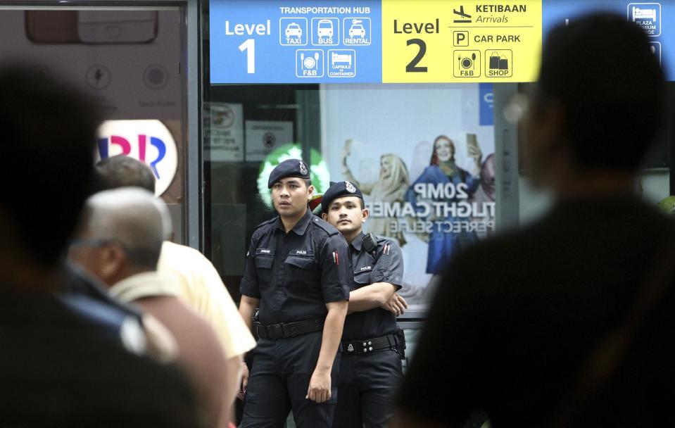 Police officers patrol inside the Kuala Lumpur International Airport in Sepang, Malaysia, Wednesday, Feb. 15, 2017. Kim Jong Nam, the half brother of North Korean leader Kim Jong Un, was assassinated Monday at the airport, telling medical workers before he died that he had been attacked with a chemical spray, a Malaysian official said Tuesday. (AP Photo)