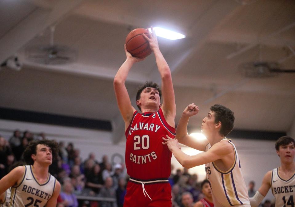 Calvary's Luke Blackford attempts a shot against Jacksonville Routt in the Class 1A New Berlin Regional final on Friday, Feb. 23, 2024. The Saints won 60-53.
