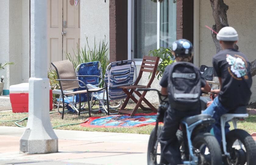 Beach chairs and a cooler rest at the corner of 16th St. and Pecan where the HBPD is investigating a stabbing attack that killed two people and injured three others that occurred at a multifamily residential complex at the corner in Huntington Beach.