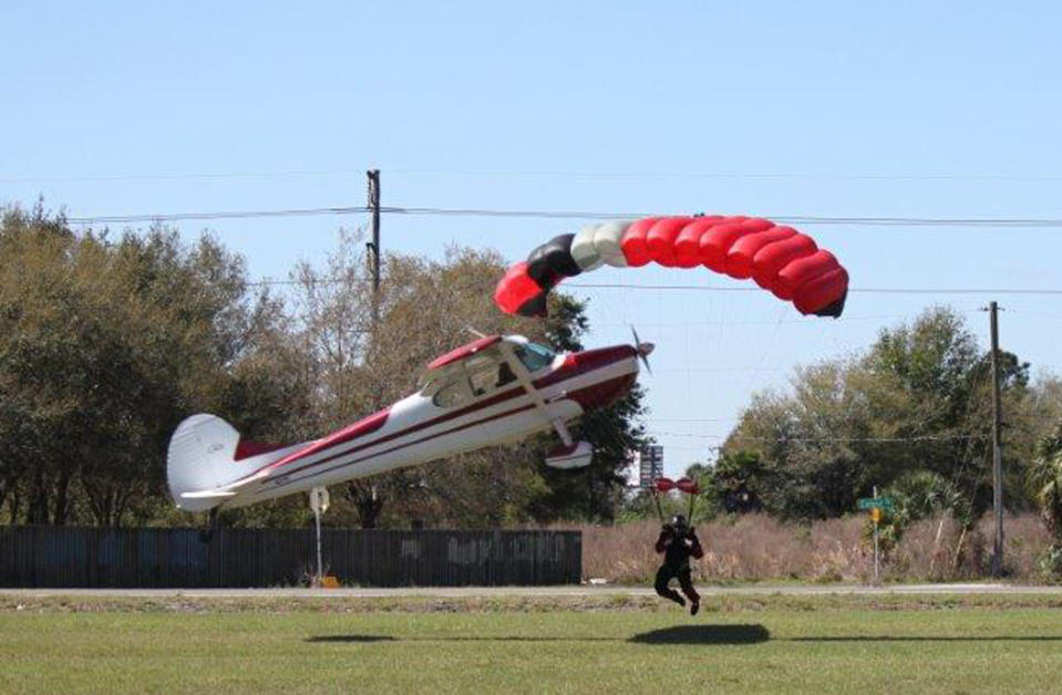 This photo released by the Polk County Sheriff's Office shows a plane getting tangled with a parachutist, Saturday March 8, 2014, at the South Lakeland Airport in Mulberry, Fla. Both the pilot and jumper hospitalized with minor injuries. (AP Photo/Polk County Sheriff's Office, Tim Telford) MANDATORY CREDIT