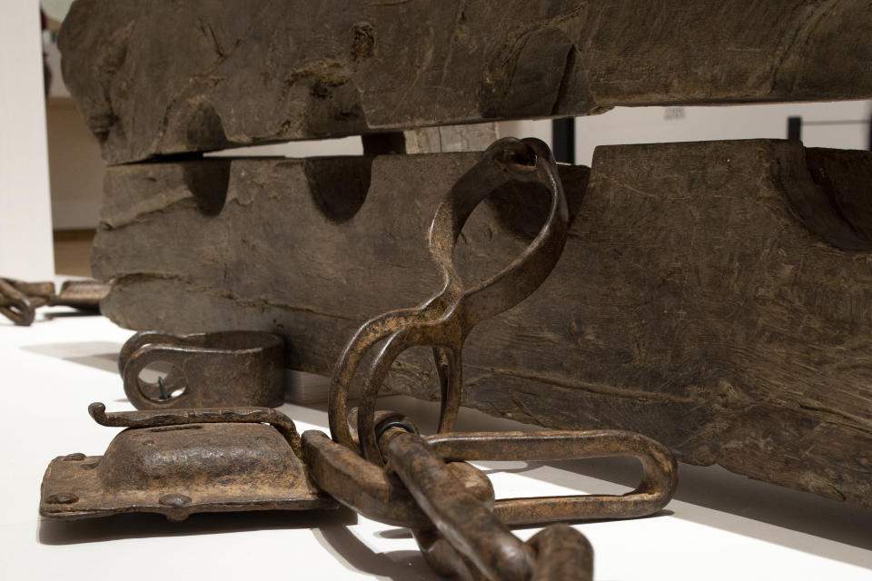 Tronco, or multiple foot stocks used to to constrain enslaved people, are seen at the Slavery exhibition Rijksmuseum in Amsterdam, Netherlands, Monday, May 17, 2021. The stark contrast between finery and brutality, wealth and inhumanity is a recurring pattern at the museum's unflinching new exhibition titled, simply, "Slavery", that examines the history of Dutch involvement in the international slave trade. (AP Photo/Peter Dejong)