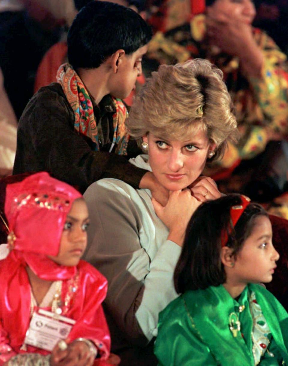 Britain's Princess of Wales sits with sick children, during a visit to the Shaukat Khanum Memorial Hospital, founded by Pakistani cricket star Imran Khan, in Lahore, Thursday Feb. 22, 1996. (AP Photo/John Giles)