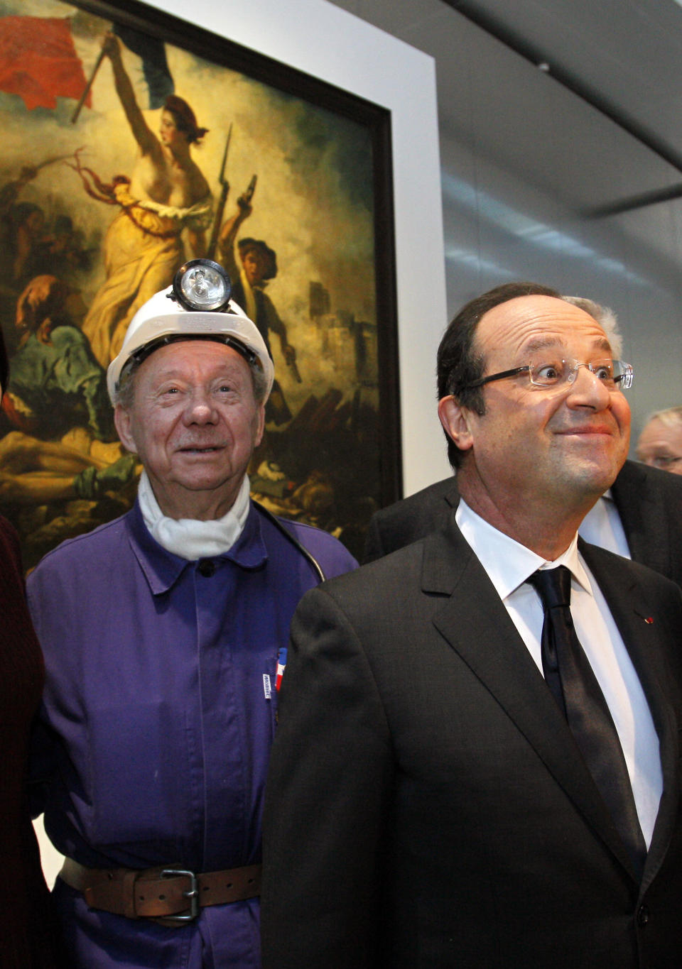 France's President Francois Hollande, right, is seen with a former miner, Lucien Laurent in front of " La Liberte Guidant le Peuple", a painting by Eugene Delacroix during the inauguration of the Louvre Museum in Lens, northern France, Tuesday, Dec. 4, 2012. The museum in Lens is to open on Dec. 12, as part of a strategy to spread art beyond the traditional bastions of culture in Paris to new audiences in the provinces. (AP Photo/Michel Spingler, Pool)