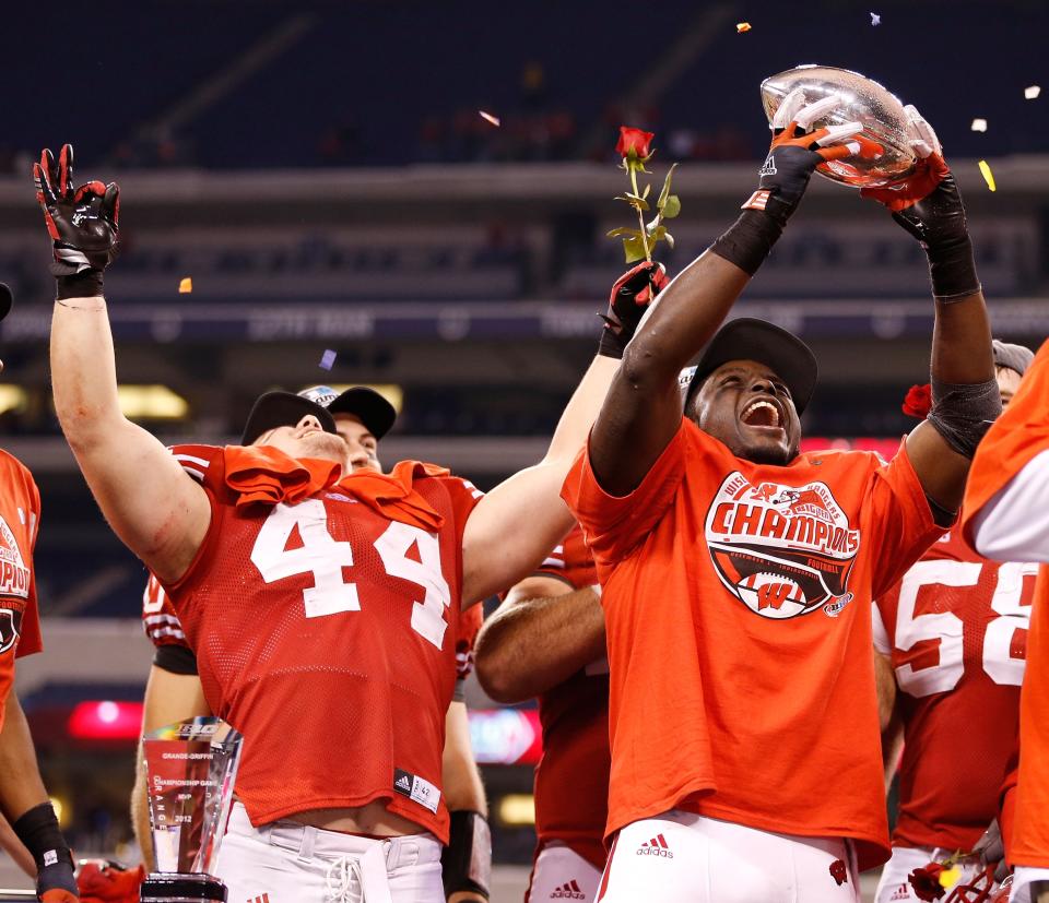 INDIANAPOLIS, IN - DECEMBER 01: Montee Ball #28 of the Wisconsin Badgers holds up the Stagg Championship Trophy with Chris Borland #44 celebrating next to him after beating the Nebraska Cornhuskers 70-31in the Big 10 Conference Championship Game at Lucas Oil Stadium on December 1, 2012 in Indianapolis, Indiana. (Photo by Gregory Shamus/Getty Images)