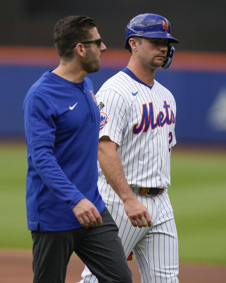 New York Mets' Pete Alonso leaves the field with a trainer after getting injured in the first inning of a baseball game against the Los Angeles Dodgers, Wednesday, May 29, 2024, in New York. (AP Photo/Frank Franklin II)