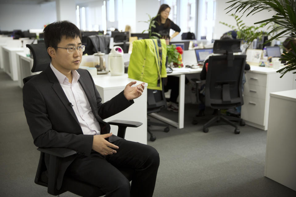 In this Oct. 31, 2018, photo, Huang Yongzhen, CEO of Watrix, speaks during an interview at his company's offices in Beijing. A Chinese technology startup hopes to begin selling software that recognizes people by their body shape and how they walk, enabling identification when faces are hidden from cameras. Already used by police on the streets of Beijing and Shanghai, “gait recognition” is part of a major push to develop artificial-intelligence and data-driven surveillance across China, raising concern about how far the technology will go. (AP Photo/Mark Schiefelbein)