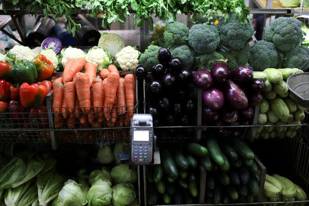A point-of-sale (POS) device is seen in a fruit and vegetables stall at Chacao Municipal Market in Caracas, Venezuela January 19, 2018. REUTERS/Marco Bello