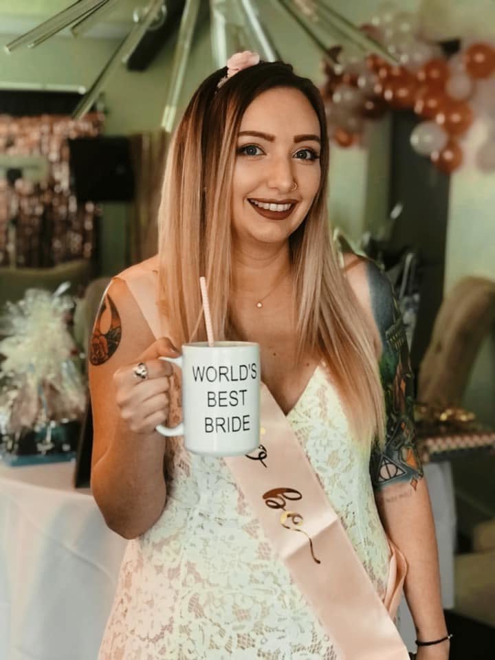 Brown holds a "World's Best Bride" mug, another nod to "The Office." (Photo: <a href="https://www.instagram.com/kayleighkill/" target="_blank">@kayleighkill</a>)