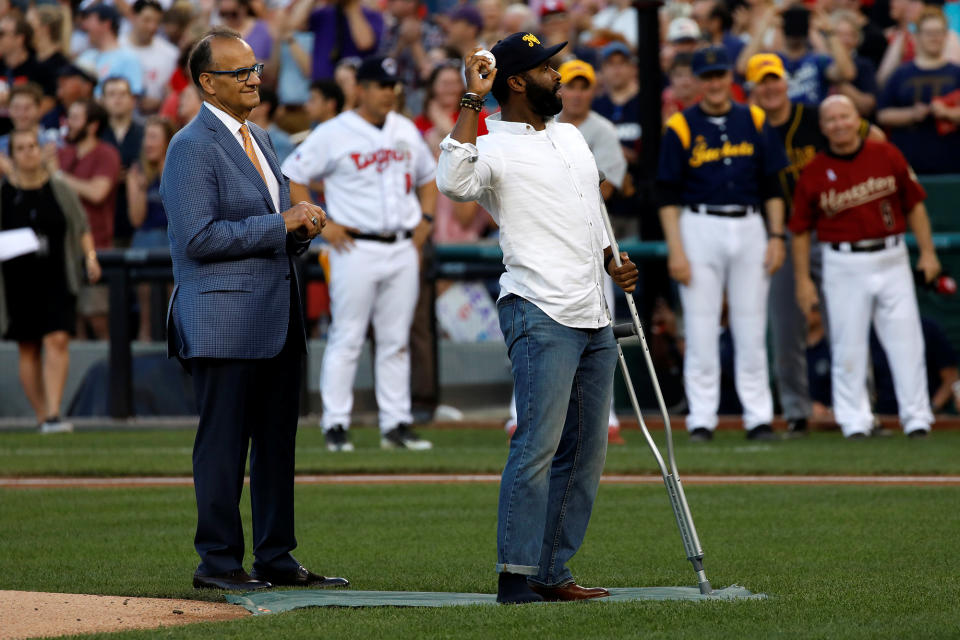 Special Agent David Bailey of the U.S. Capitol Police, with former Yankees manager Joe Torre, throws out the first pitch during the congressional baseball game at Nationals Park. (Photo: Aaron P. Bernstein/Reuters)