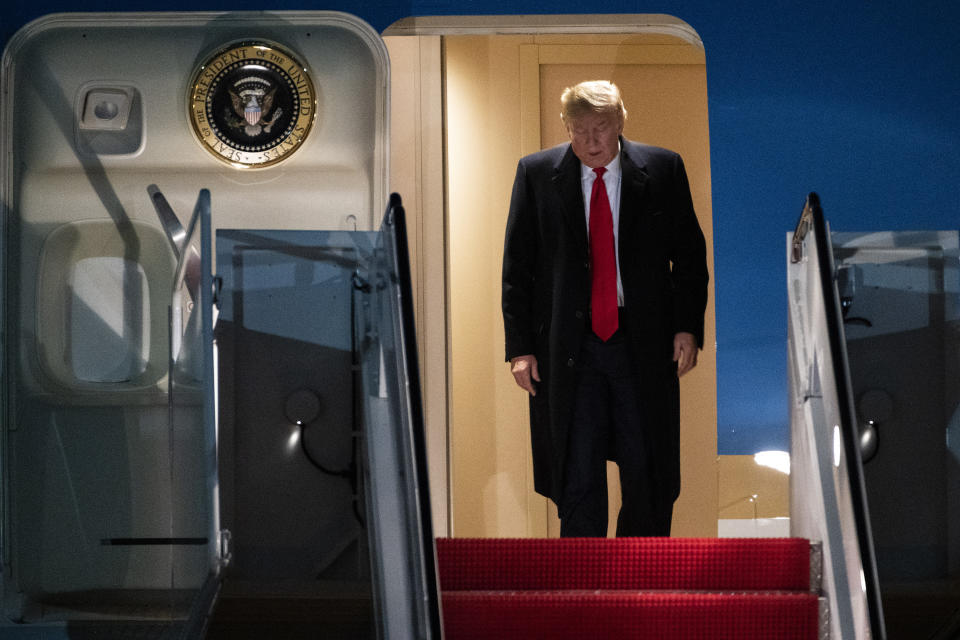 President Donald Trump exits Air Force One on Wednesday, Jan. 22, 2020, at Andrews Air Force Base, Md., after returning from the World Economic Forum in Davos, Switzerland. (AP Photo/Kevin Wolf)