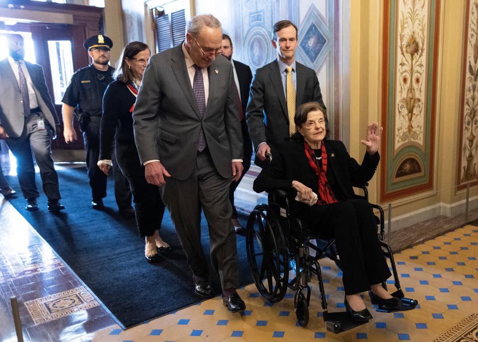 Senate Majority Leader Charles Schumer, D-N.Y., escorts Sen. Dianne Feinstein, D-Calif., as she arrives at the U.S. Capitol on May 10, 2023, after an absence due to health issues.