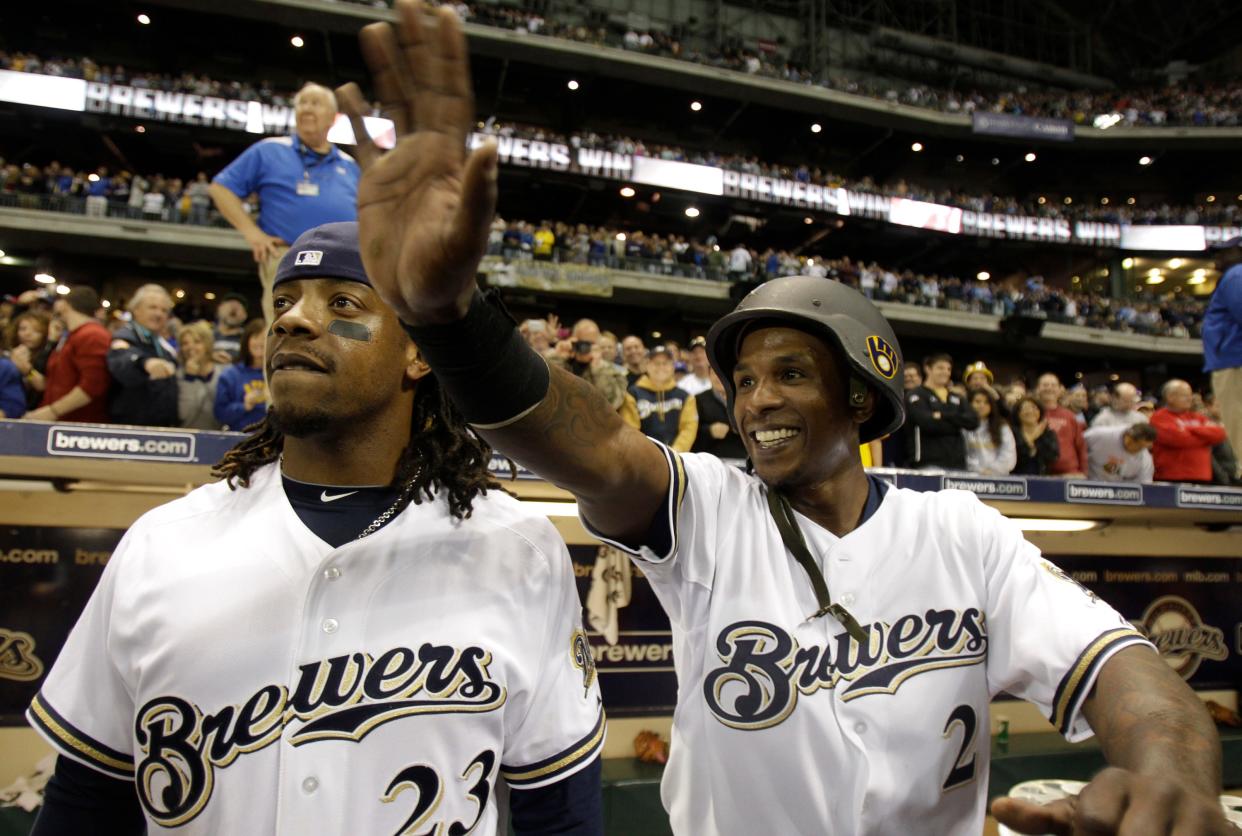 Milwaukee Brewers'  Rickie Weeks and Nyjer Morgan watch the Cubs/Cardinals game after beating the Florida Marlins at Miller Park on Friday, September 23, 2011. The Cubs beat the Cardinals and guaranteed the Brewers the 2011 NL Central title.