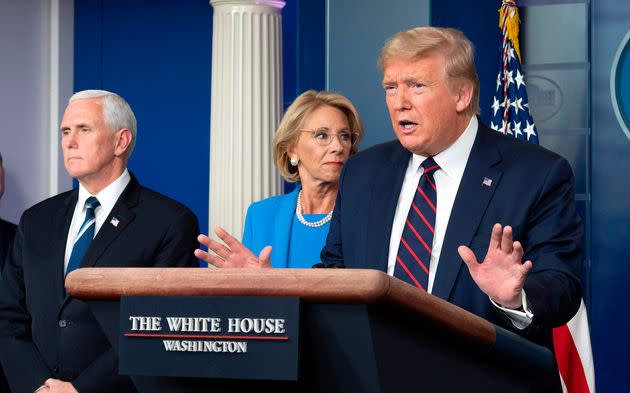 Then-Education Secretary Betsy DeVos stands with President Donald Trump and Vice President Mike Pence during a coronavirus update in March 2020. (Photo: JIM WATSON via Getty Images)