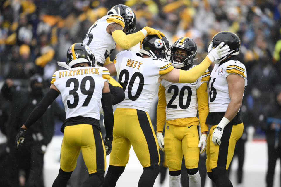 Pittsburgh Steelers outside linebacker T.J. Watt (90) celebrates with teammates, from left, free safety Minkah Fitzpatrick (39), cornerback Arthur Maulet (35), cornerback Cameron Sutton (20) and outside linebacker Alex Highsmith (56) after recording a forced fumble against Baltimore Ravens quarterback Tyler Huntley during the first half of an NFL football game, Sunday, Jan. 9, 2022, in Baltimore. (AP Photo/Nick Wass)