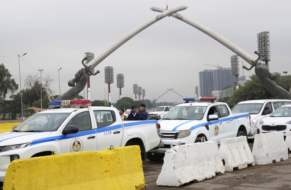 Iraqi traffic police officers stand at a busy intersection inside the Green Zone, in Baghdad, Iraq, Sunday, Jan. 8, 2023. (AP Photo/Hadi Mizban)