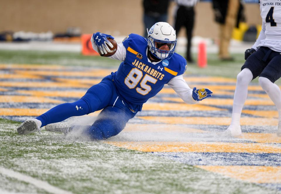 South Dakota State’s Tucker Kraft uses the existing layer of snow to slide into the end zone for the first touchdown of the FCS semifinal game against Montana State on Saturday, December 17, 2022, at Dana J. Dykhouse Stadium in Brookings, SD.