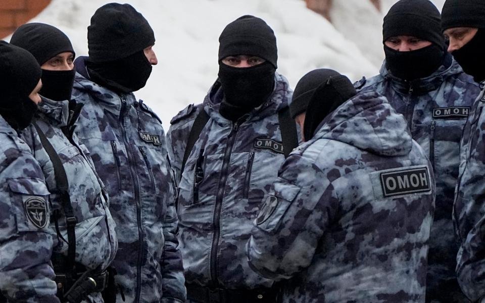 Riot police officers guard the area near the Church of the Icon of the Mother of God Soothe My Sorrows in Moscow