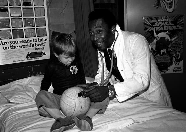Pele plays the role of doctor while visiting patients at Middlesex Hospital Children's Ward in April 1981