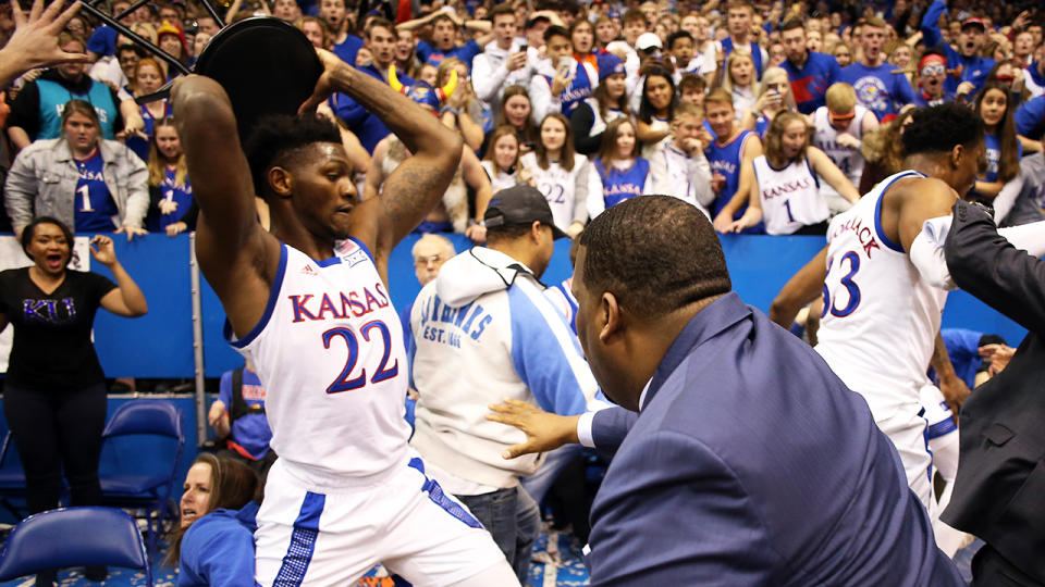 Silvio De Sousa of the Kansas Jayhawks picks up a chair during a brawl as the game against the Kansas State Wildcats ends at Allen Fieldhouse. (Photo by Jamie Squire/Getty Images)