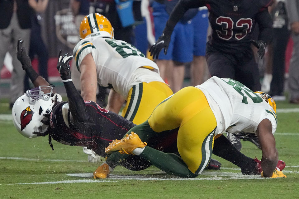 Arizona Cardinals running back Jonathan Ward, left, and Green Bay Packers running back Kylin Hill (32) are injured on a play during the second half of an NFL football game, Thursday, Oct. 28, 2021, in Glendale, Ariz. Both players left the game. (AP Photo/Rick Scuteri)