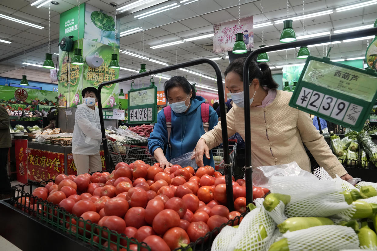 Residents wearing masks shop at a supermarket in the Chaoyang district of Beijing, Monday, April 25, 2022. Mass testing started Monday in Chaoyang district, home to more than 3 million people in the Chinese capital, following a fresh COVID-19 outbreak. (AP Photo/Ng Han Guan)