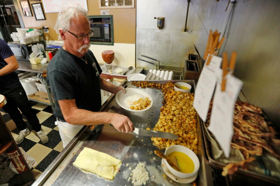 Andrew Dillon, who owned the restaurant for over 30 years, prepares breakfast at Dillon's Restaurant on County Street in New Bedford.