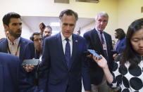 Sen. Mitt Romney, R-Utah, is surrounded by reporters as he walks to the Senate chamber for votes, at the Capitol in Washington, Thursday, June 10, 2021. Sen. Romney is working with a bipartisan group of 10 senators negotiating an infrastructure deal with President Joe Biden. (AP Photo/J. Scott Applewhite)