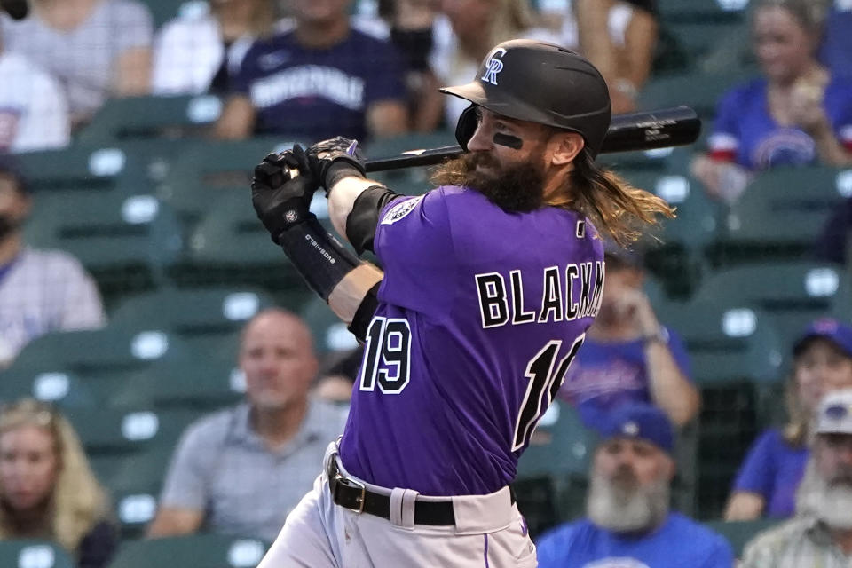 Colorado Rockies' Charlie Blackmon watches his RBI single off Chicago Cubs starting pitcher Kyle Hendricks during the first inning of a baseball game Monday, Aug. 23, 2021, in Chicago. Connor Joe scored on the play. (AP Photo/Charles Rex Arbogast)