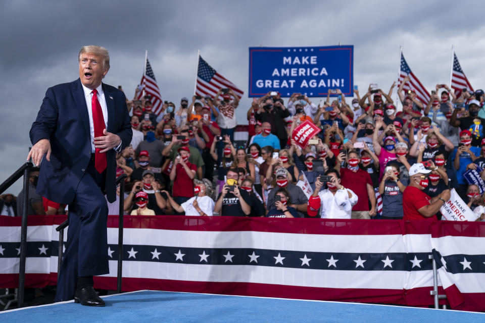 President Donald Trump reacts to the crowd as he arrives to speak at a campaign rally at Smith Reynolds Airport, Tuesday, Sept. 8, 2020, in Winston-Salem, N.C. (AP Photo/Evan Vucci)