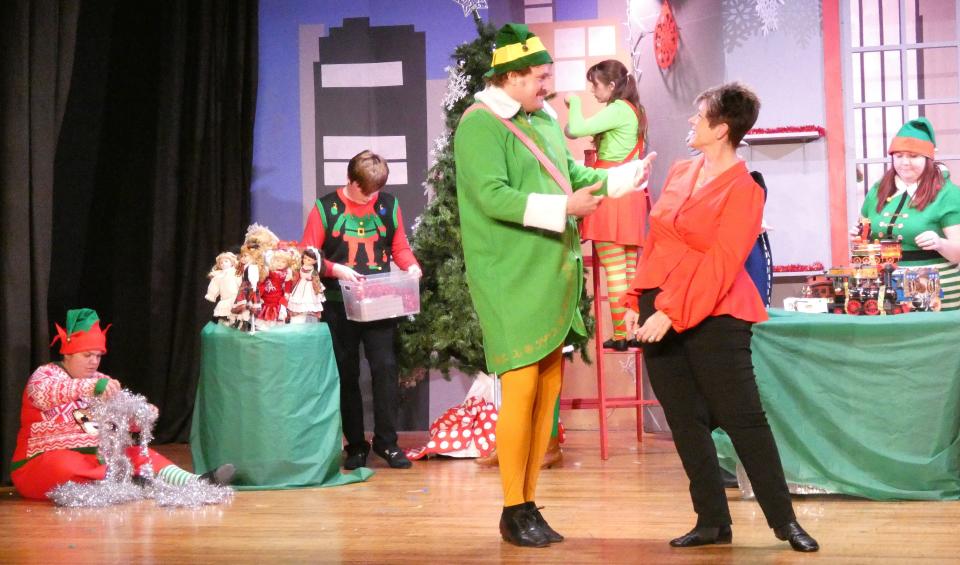 As Buddy and the Macy’s store manager, Eric Julian “E.J.” Walker, left, and Patty Schwall rehearse a scene from Bucyrus Little Theatre’s production of “Elf: The Musical” on Monday evening.