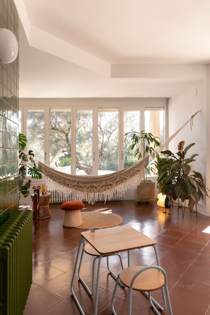 Hammock hanging in living area of tiled living area.