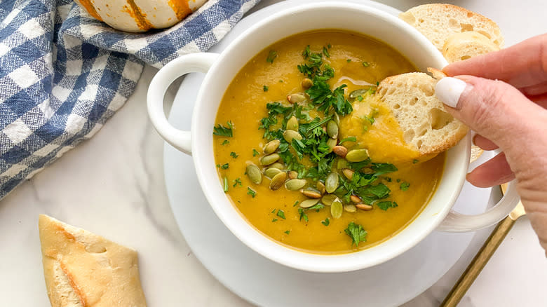 dipping bread into soup