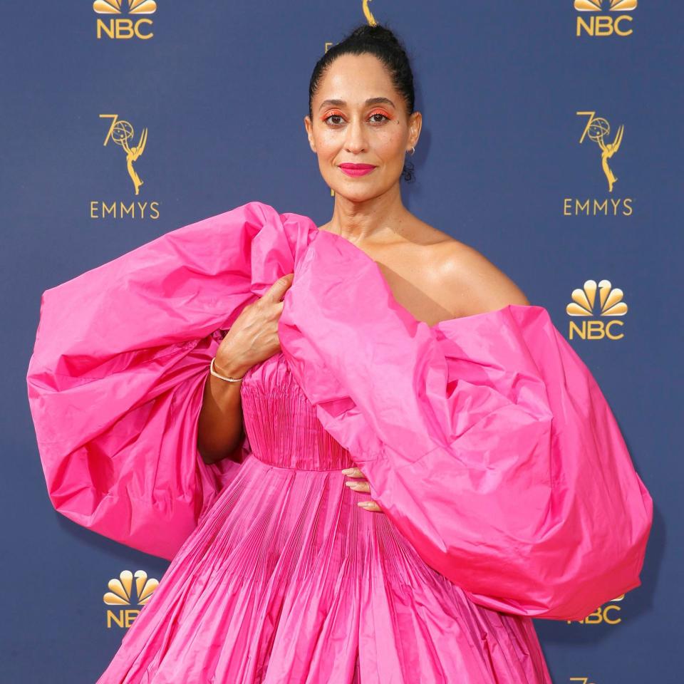 Tracee Ellis Ross took to the Emmy Awards red carpet in a shocking pink beauty look that played off her Valentino Couture gown.