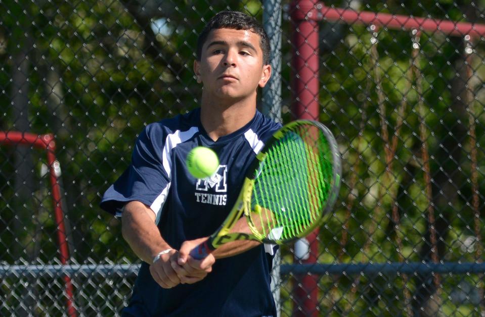 Monomoy's Ryan Casey returns a shot against a Sandwich player.