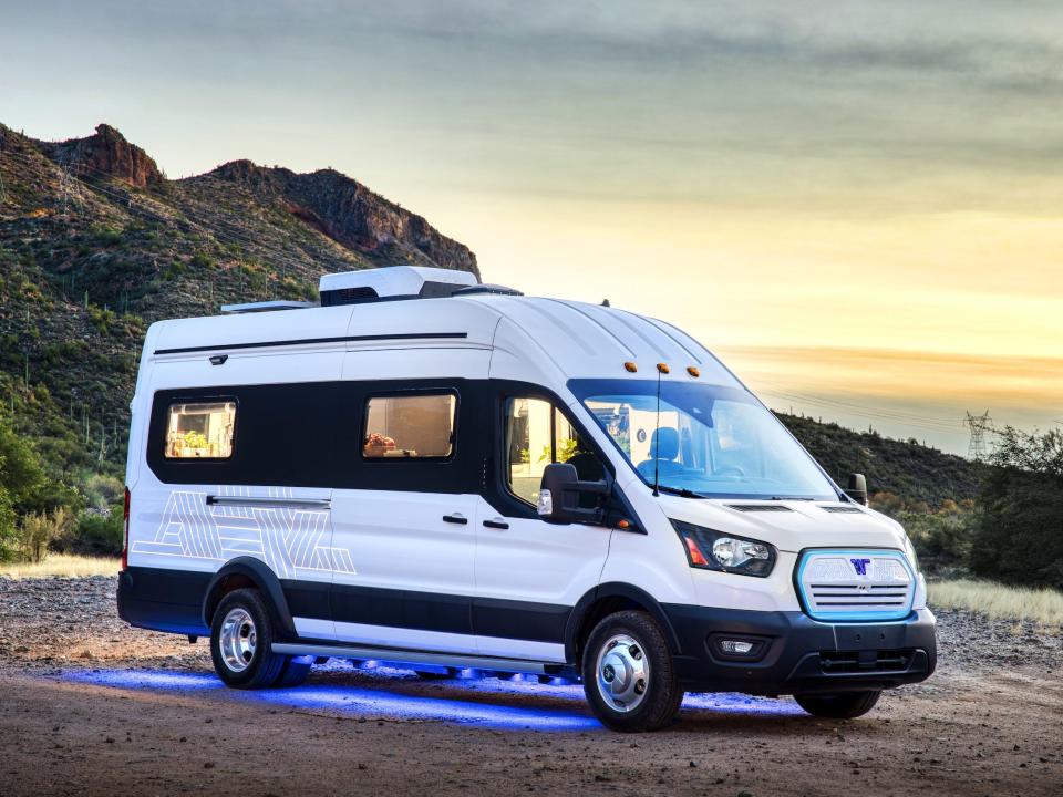 Winnebago Industries' e-RV with blueish purple lights on the underbelly.